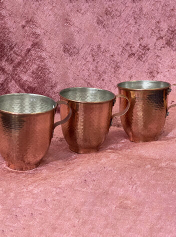 Set of three copper mugs with handles