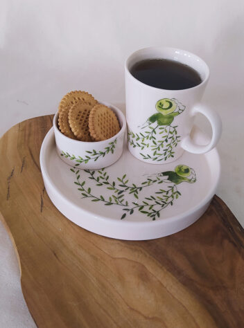 A set of ceramic cups, trays, and sugar bowl of the girl in green