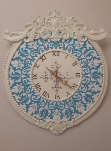 Wall clock with blue embossed flower design