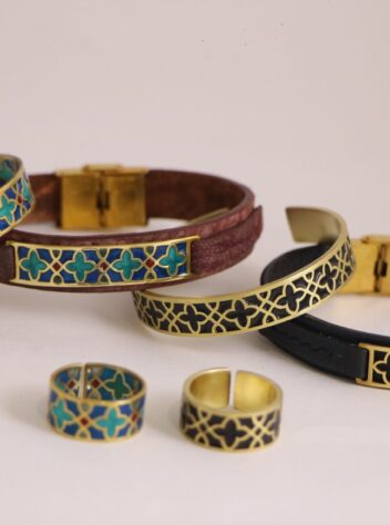 A set of brass rings and bracelets with tile designs