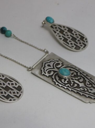 set of Silver earrings with a bush pattern and a tree of life Silver necklace with turquoise gems