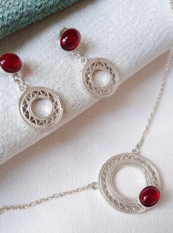 Silver sun necklace and earrings with red gems