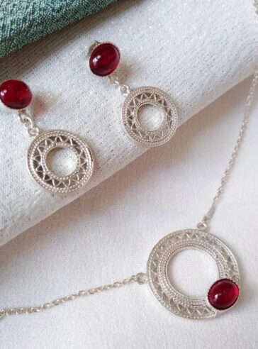 Silver sun necklace and earrings with red gems