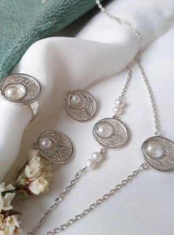 A set of silver necklaces, earrings and rings with eye and teardrop designs