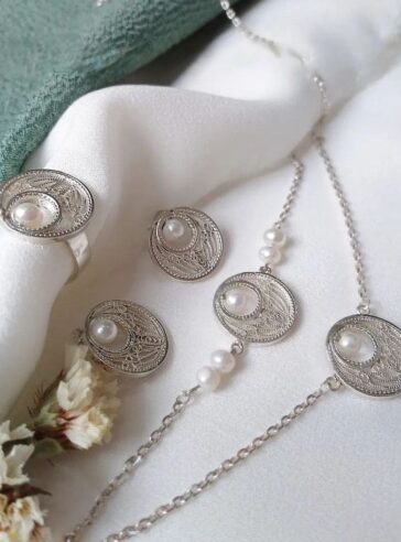 A set of silver necklaces, earrings and rings with eye and teardrop designs